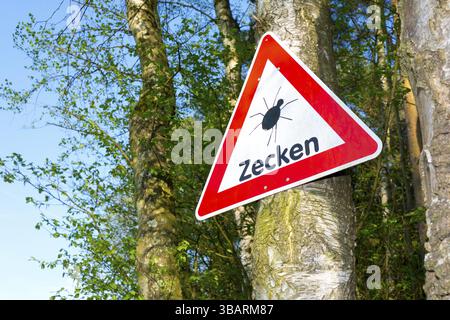 Un segnale di avvertimento avverte delle zecche, Assia, Repubblica Federale tedesca Foto Stock