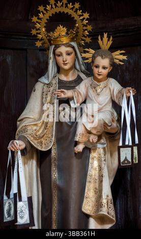 Colunga, Spagna - 04-28-2025: Statua (XIX secolo) di Maria e Gesù che donano lo scapolare per liberare le anime dal purgatorio. Foto Stock