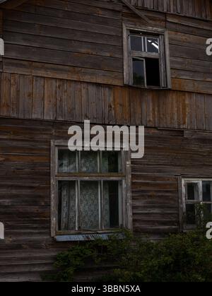 Finestre in legno d'epoca rotte su una casa abbandonata Foto Stock