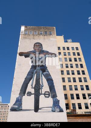 Il murale King of the Road di Case Maclaim nel centro di Houston, Texas. Il murale mostra un ragazzo afroamericano sorridente sulla sua nuova bicicletta. Foto Stock