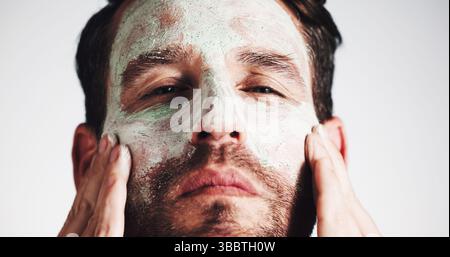 Maschera viso, pelle e argilla con ritratto dell'uomo in studio per la bellezza, trattamenti termali e dermatologia. Cosmetici, prodotti per l'igiene personale e pulizia dei pori Foto Stock