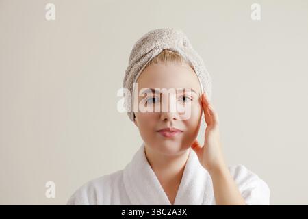 Modello di bellezza con una pelle sana e pulita in bagno, primo piano. Donna che fa esercizi per migliorare la pelle a casa. Spa, cura della pelle e benessere Foto Stock