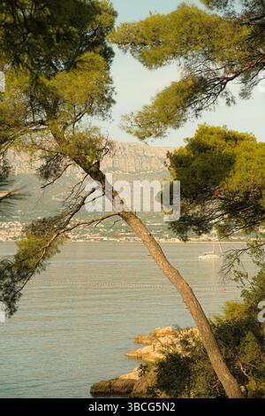 Vista costiera del mare Adriatico vicino a Spalato, Croazia, con acque cristalline e verdi colline circostanti Foto Stock