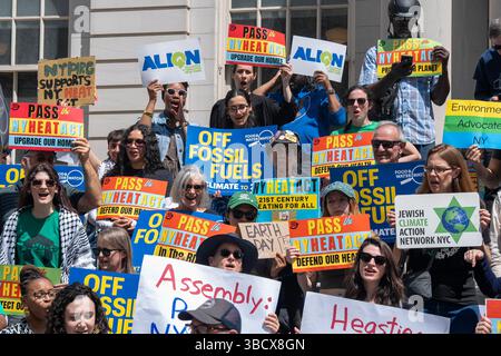 Il raduno della giornata della Terra sui gradini del municipio di New York per sostenere l'approvazione del NY HEAT Act, che abbasserà le bollette energetiche e porrà fine ai massicci sussidi all'industria del gas frantumato. Foto Stock