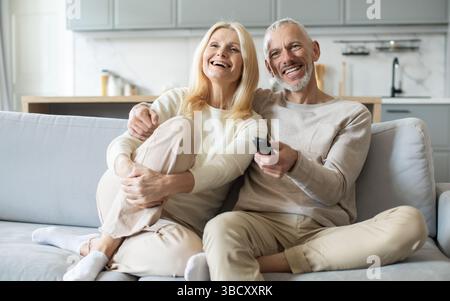 Coppia felice che si goda una serata intima insieme guardando la televisione a casa Foto Stock