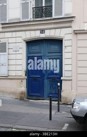 Distintiva porta di legno blu con il numero 54 su un edificio di Parigi Foto Stock
