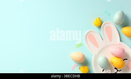 Banner di buona Pasqua. Uova di Pasqua e piatto sotto forma di coniglietto pasquale su sfondo blu. Foto Stock