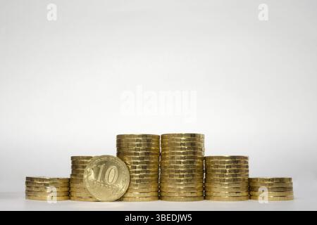 Sei pile di monete altezza crescente simmetricamente su uno sfondo bianco, pockmarked sorge sul bordo del Russo 10 ruble coin Foto Stock