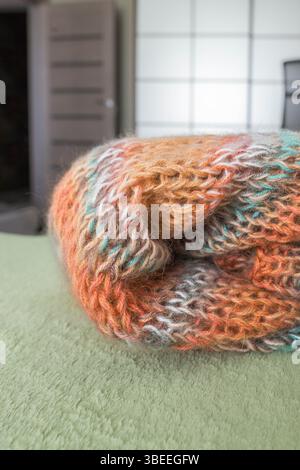 Cardigan in mohair lavorato a maglia dai colori caldi. Lavorata a maglia. Guardaroba autunno e inverno. Casa accogliente. Cose calde. Ripetizione di Unione. Maglia grossa. Foto Stock
