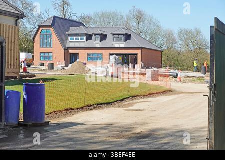 Nuove case su terreni agricoli lavori di costruzione in corso parte 15 case recintate in vendita a milioni di sterline più a Doddinghurst Essex Inghilterra Regno Unito Foto Stock
