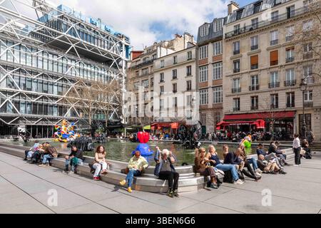 Persone che si rilassano da Fontaine Stravinsky a Place Igor Stravinsky nel 4 ° arrondissement di Parigi, Francia Foto Stock