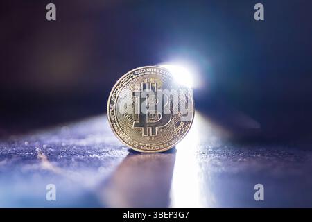 Primo piano simbolico della criptovaluta Bitcoin Coin retroilluminata Foto Stock