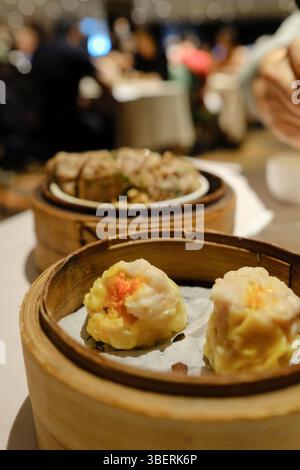 Primo piano di un piroscafo di bambù di siu mai, con un piroscafo di ngao yuk (polpette di manzo) sullo sfondo presso l'Eight, un ristorante yumcha a Sydney Foto Stock