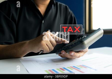 Primo piano di un uomo d'affari che calcola l'imposta con calcolatrice e grafici sul piano di lavoro, pianificazione finanziaria, contabilità e dichiarazione dei redditi. Foto Stock