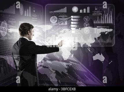 Young businessman working with modern virtual panel Foto Stock