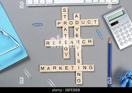 Concetto di Web marketing con parole tratte da cubi. Natura morta del luogo di lavoro in ufficio con parole incrociate. Superficie grigia piatta con tastiera per computer e notebook. Foto Stock