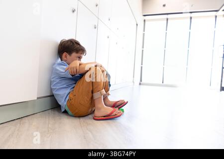armadietti bianchi che rivestono il corridoio su pavimento in legno, con infradito rosse appoggiate vicino all'ingresso della porta di vetro Foto Stock