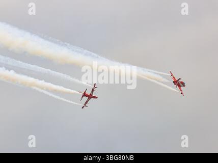 Spettacolo acrobatico dell'HAWK MK132 della squadra di aeronautica dell'India Air Force Aerobatics su formazioni con fumi colorati che fuoriescono dall'aereo. Foto Stock