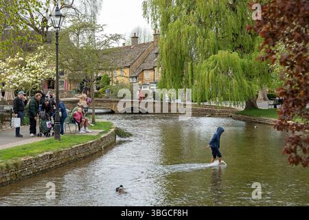 Bridge, River Windrush, People, Child playing in the water, Bourton-on-the-Water, Cotswolds, Gloucestershire, Inghilterra, gran Bretagna Foto Stock