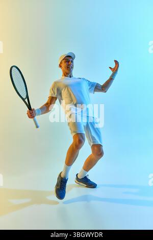 Tennista che celebra la vittoria, sorridendo con sicurezza in posa trionfale e stringendo pugno con gioia su sfondo blu-giallo brillante Foto Stock