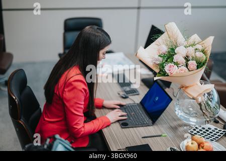 Giovane professionista in un ufficio moderno che lavora su un progetto importante Foto Stock