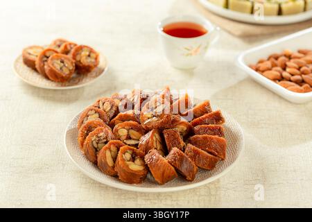 Piatto di dolci arabi mediorientali, mandorle knafeh. Foto Stock