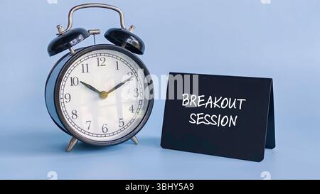 Sveglia con il cartello della tabella che mostra la "sessione di breakout" che rappresenta la discussione pianificata, la gestione del tempo e la collaborazione di gruppo Foto Stock