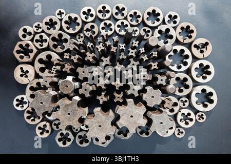 Rubinetti e stampi per filettature metalliche. Utensili per il taglio di filettature interne ed esterne, primi piani. Rubinetti e stampi per filettature metalliche. Utensili per taglio esterno Foto Stock
