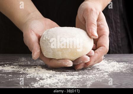 Mani femminili che preparano impasti fatti in casa Foto Stock