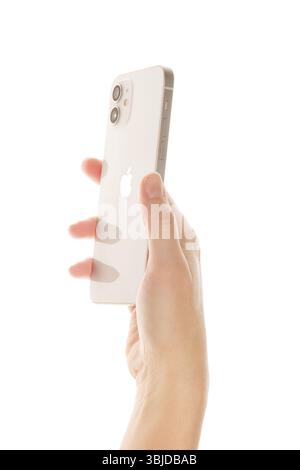 Bratislava, Slovacchia - 7 dicembre 2020. IPhone 12 bianco in mano femmina isolato Foto Stock