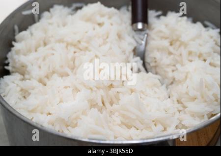 Gusta il delizioso e soffice riso cotto preparato in una robusta pentola di metallo per il tuo pasto Foto Stock