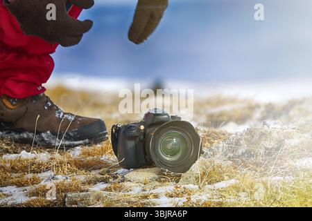 Uomo fotografo backpacker con telecamera e prendere foto. Stile di vita viaggio concetto hobby avventura vacanze attive outdoor Foto Stock