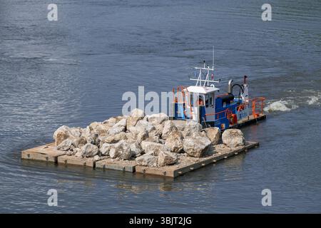 Villey-le-sec, Francia - Vista su una piccola barca a rimorchio spinge una chiatta carica per lavori fluviali sulla Mosella. Foto Stock