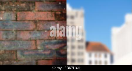Design piatto che mostra pareti in mattoni rossi sulla sinistra e edifici bianchi sfocati sotto il cielo blu Foto Stock
