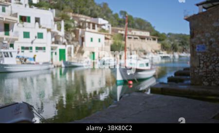 Scenario sfocato di barche ormeggiate nel pittoresco porto di cala figuera con architettura mediterranea a maiorca, con effetti bokeh e schiena sfocata Foto Stock