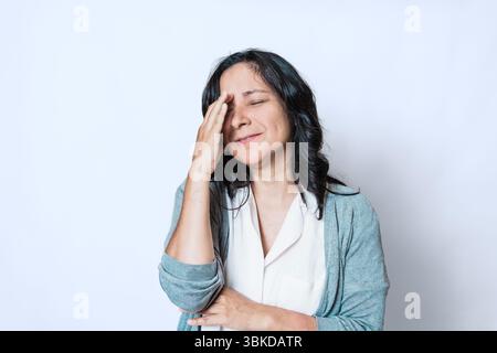 giovane donna ispanica adulta nei suoi 40 anni con mal di testa, ritratto di donna preoccupata e triste con problemi di salute mentale Foto Stock