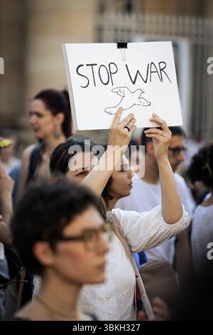 Una donna ha un cartello con scritto "Stop War" durante la manifestazione per la pace nel vicino e medio Oriente a Place Pantheon. Mentre la guerra tra Israele e Iran si intensifica quotidianamente, un gruppo di associazioni tra cui Iran Justice ha organizzato una manifestazione in Piazza Pantheon a Parigi per esprimere il loro rifiuto del conflitto tra Israele e Iran. Ponendo i leader iraniani e israeliani Khamenei e Netanyahu per il loro mancato rispetto del diritto internazionale, gli oratori, compresi i parlamentari di sinistra, hanno tutti chiesto la fine della guerra e il rispetto dei civili e dei loro diritti. Foto Stock