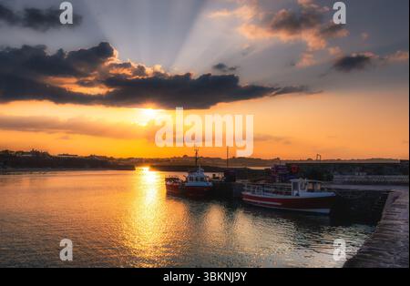 Solstizio d'estate al tramonto sul Rush Harbour con la marea in avanti Foto Stock