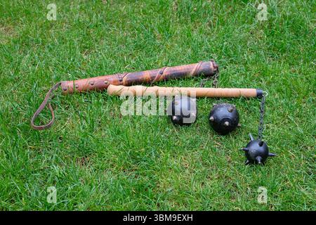 L'arma decorativa medievale o la mazza Morgenstern con punte giace sull'erba verde. Arti marziali e tornei. Foto Stock