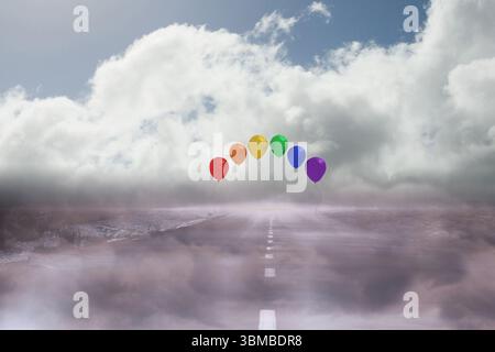 I palloncini arcobaleno fluttuano sopra l'autostrada nebbiosa in un design piatto, mostrando la linea centrale della strada Foto Stock