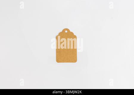 Etichetta in carta kraft marrone vuota con foro per l'etichettatura su sfondo bianco Foto Stock