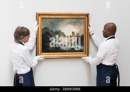 LONDRA, REGNO UNITO - 27 GIUGNO 2025: Art Handlers Hold a Rediscovered painting to be seen in Public for the first time in over 150 years intitolato 'The Rising Squall, Hot Wells, from St Vincent's Rock, Bristol' di Joseph Mallord William Turner, Estimate: £200.000 - 300.000 during a photocall at Sotheby's Auction House ahead of Old Masters sale in London, United Kingdom on June 27, 2025. (Foto di Wiktor Szymanowicz/NurPhoto) Foto Stock