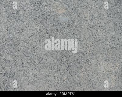 telaio completo in asfalto grigio con superficie punteggiata scanalata in consistenza ruvida, pavimento in cemento o cemento o rivestimento delle pareti come sfondo liscio testurizzato Foto Stock