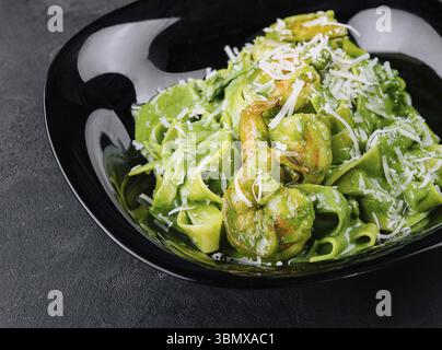 Natura morta, deliziosa cena con tagliatelle di pasta di spinaci con gamberi Foto Stock