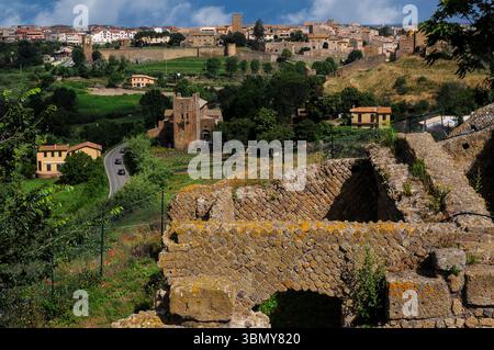 Un complesso di terme, abitazioni e altre rovine di epoca romana sopravvivono sull'acropoli terrazzata dell'antica città etrusca e romana di Tuscana, fondata nel VII secolo a.C. Molte pareti fronteggiate in opus reticulatum: Blocchi di tufo vulcanico che formano modelli diagonali. Tuscania in provincia di Viterbo, Lazio, Italia, comprende gli insediamenti etruschi, romani e medievali. Foto Stock