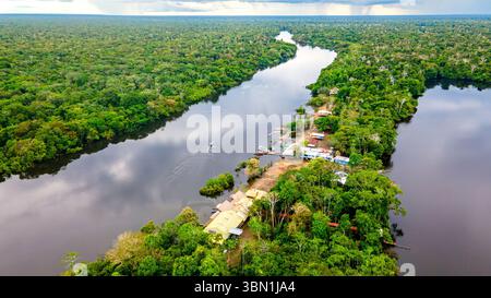Splendida ripresa aerea che cattura la lussureggiante giungla tropicale e il tranquillo paesaggio fluviale di Leticia, Amazonas in Colombia, mostrando la sua bellezza naturale. Foto Stock