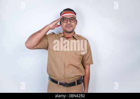 Un uomo funzionari pubblici asiatici o funzionari statali è con uniforme marrone e rosso e bianco cerchietto ordine braccio, posa di saluto . Sul backgrou bianco Foto Stock