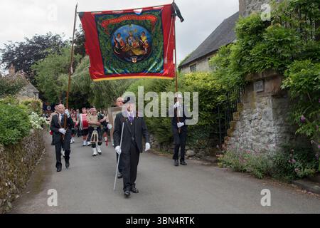 Inghilterra, tradizione, cultura, tradizione. Anni '2020 Regno Unito. Parwich, Oddfellows. La leale Laurel e Crown Lodge. Gli Oddfellows sfilano intorno al villaggio guidati dal Maestro delle cerimonie Mark Edge, la dispensazione viene portata sotto il Lodge Banner da Arnold Chadfield. Parwich si sveglia la settimana. Parwich, Derbyshire, Inghilterra 1 luglio 2023 UK 2020s HOMER SYKES Foto Stock