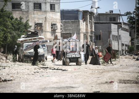 Tulkarm, Palestina. 2 luglio 2025. Le famiglie palestinesi portano con sé i loro effetti personali mentre fuggono dal campo profughi di Tulkarm. Le forze israeliane hanno permesso ai residenti di recuperare i loro effetti personali dopo aver emesso avvisi di demolizione per diverse case, nel mezzo di un'offensiva durata mesi in Cisgiordania che ha allontanato circa 35.000 palestinesi dalle loro case nel campo profughi di Tulkarm. Credito: SOPA Images Limited/Alamy Live News Foto Stock