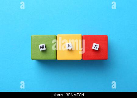 Cubi colorati e parola Max con lettere su sfondo azzurro, vista dall'alto Foto Stock
